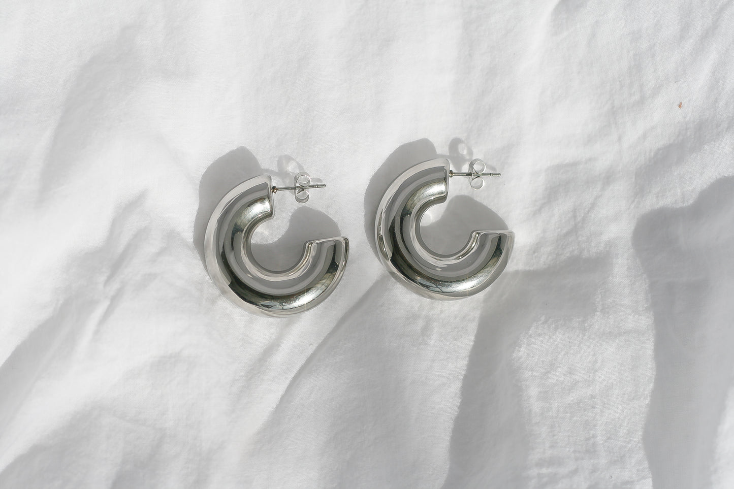 Sculpted Elegance Silver Hoop Earrings